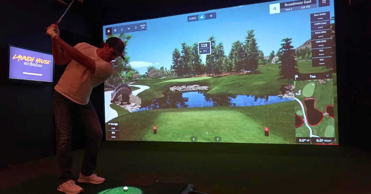 Playing golf on Launch House Golf Simulator with Uneekor Eye XO Launch Monitor