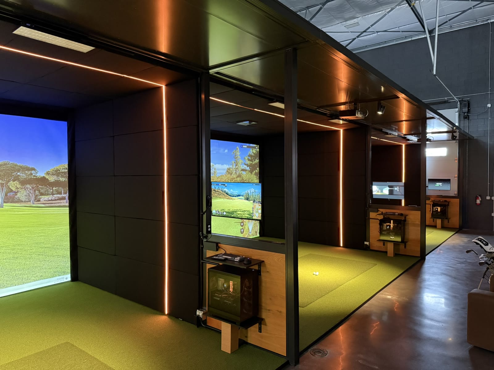 Finished Rapid Bay multi-bay install near Austin, TX — black magnetic panels with copper LED accents and turf flooring