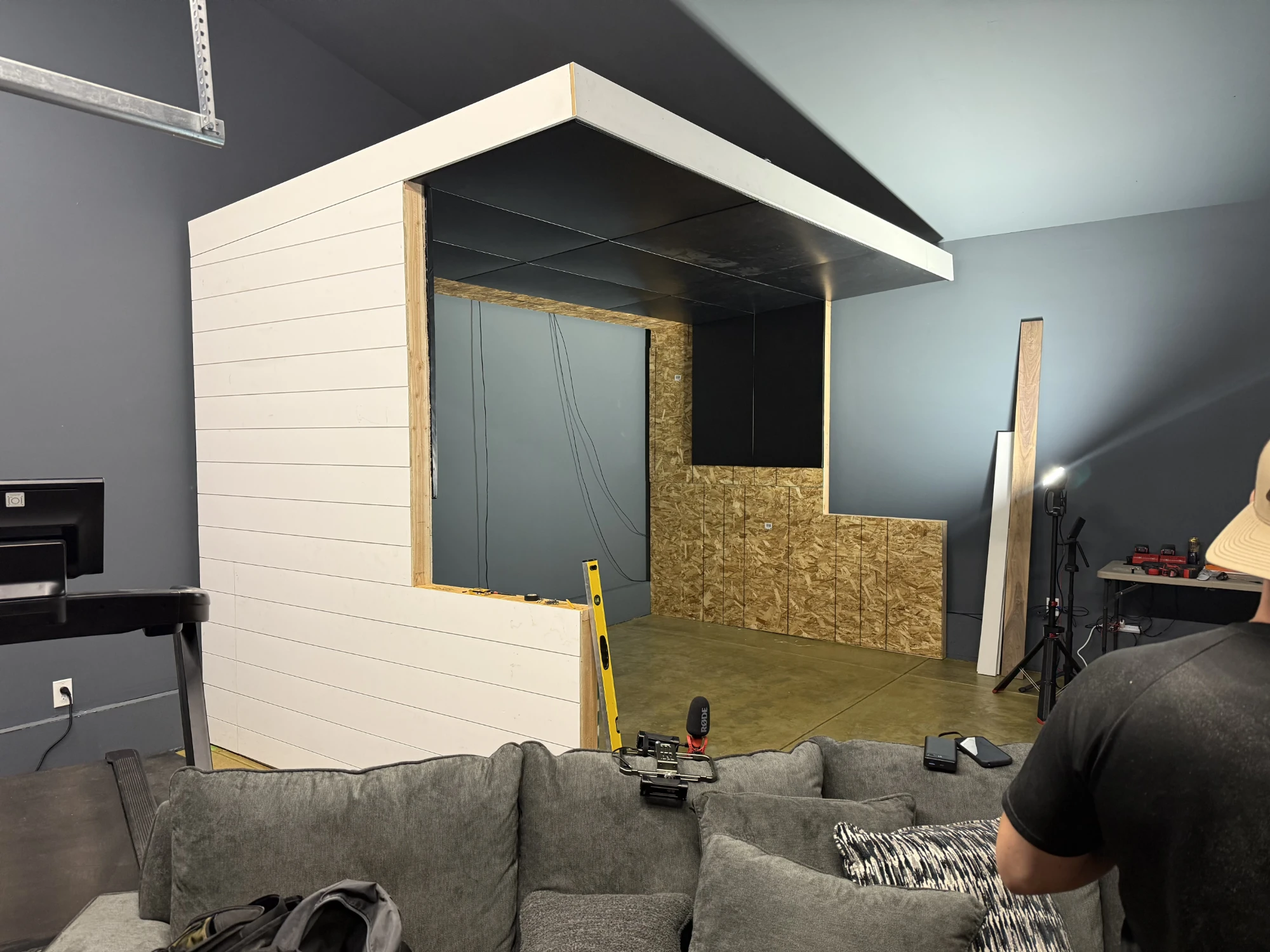 Cantilevered enclosure ceiling floating above the pony wall, showing the swing-clearance gap